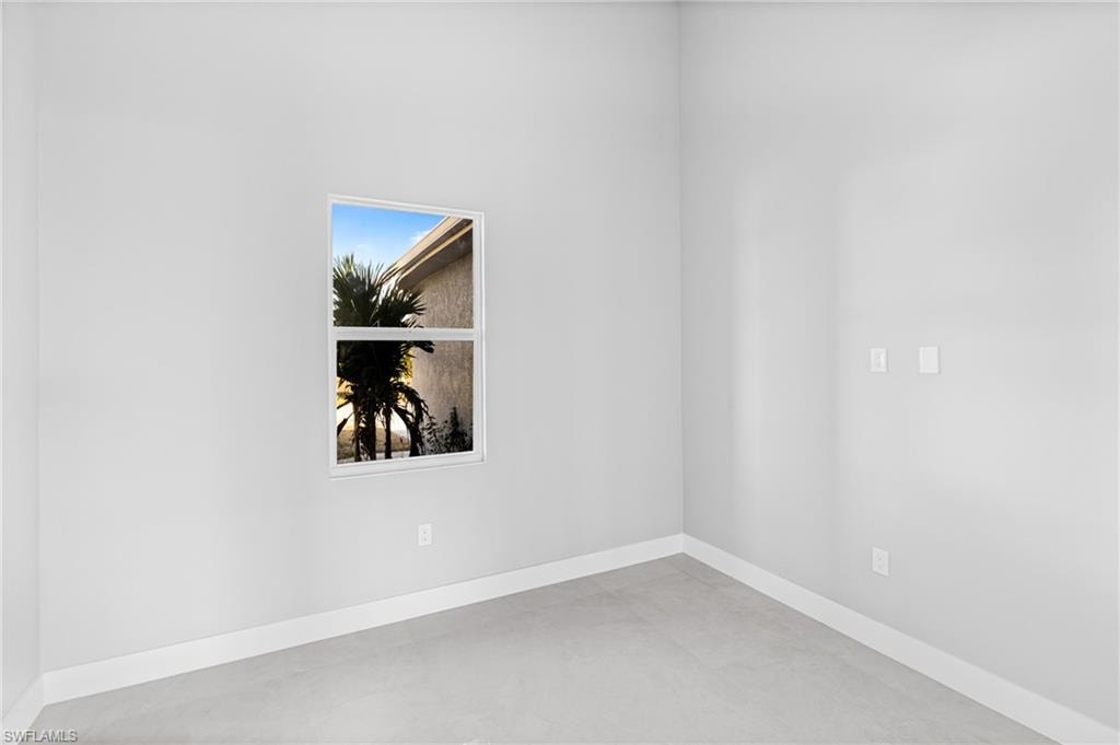 Empty room featuring baseboards