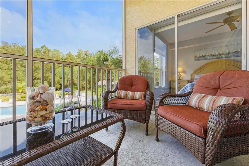 "Wine down" on the lanai, and enjoy the pool and spa view, with swaying palms