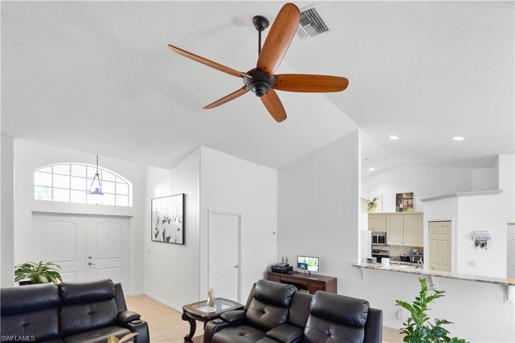 Living room featuring lofted ceiling and a ceiling fan