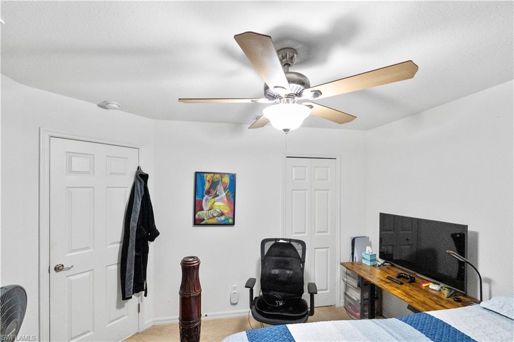 Bedroom with a ceiling fan and a closet