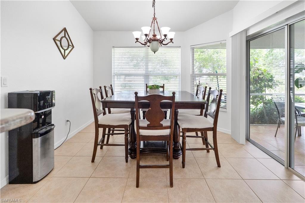 Dining space featuring a chandelier and light tile patterned flooring