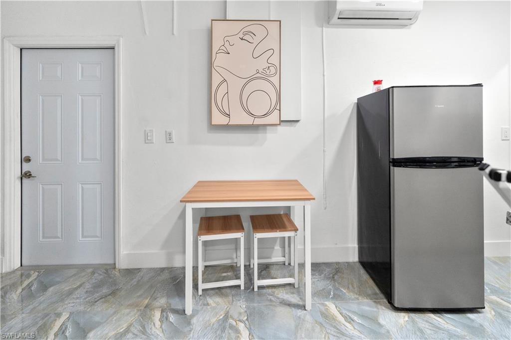 Detailed view of freestanding refrigerator and a wall mounted mini split