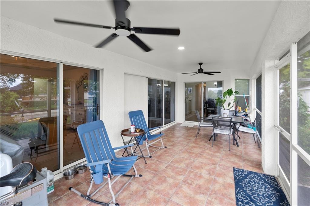 Sunroom / solarium with a ceiling fan, outdoor dining space, and recessed lighting