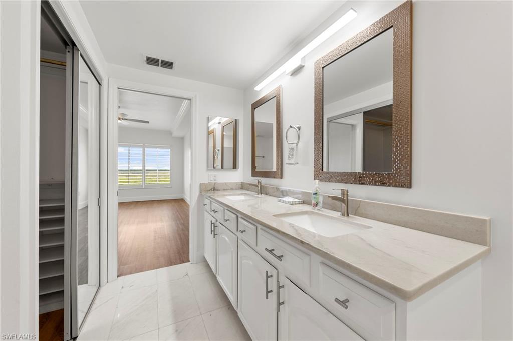 Dual vanity with undermount sinks, stone countertops, and brushed nickel fixtures