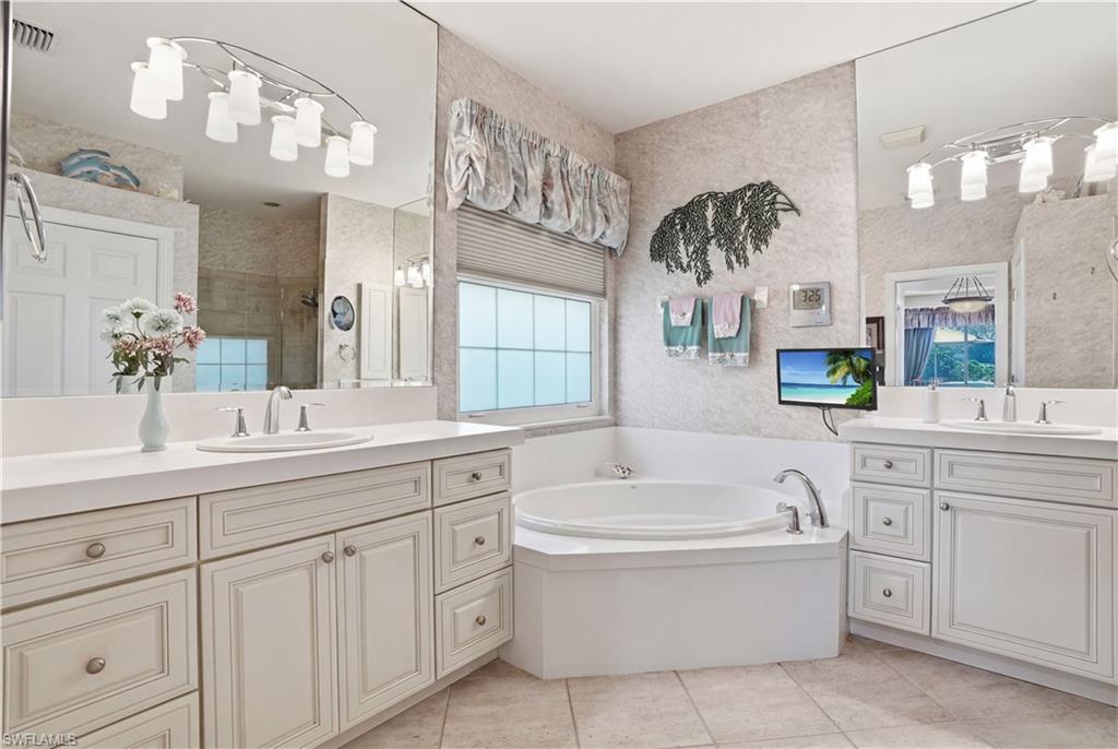 Ensuite bathroom with two separate sink areas, soaking tub and a spacious walk in shower.