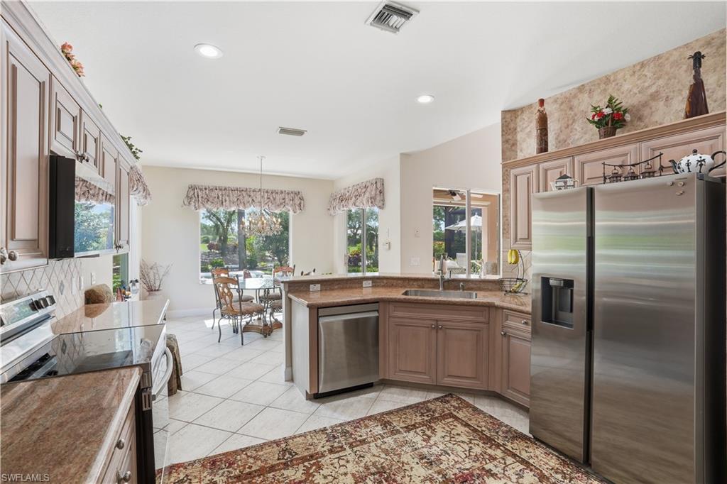Ample prep space, stainless steel appliances, and warm wood cabinetry complete this well-appointed kitchen.