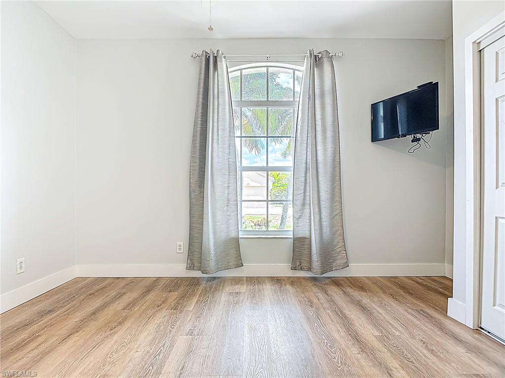 Spare room featuring baseboards and light wood finished floors