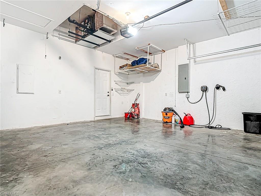 Garage with a garage door opener and electric panel