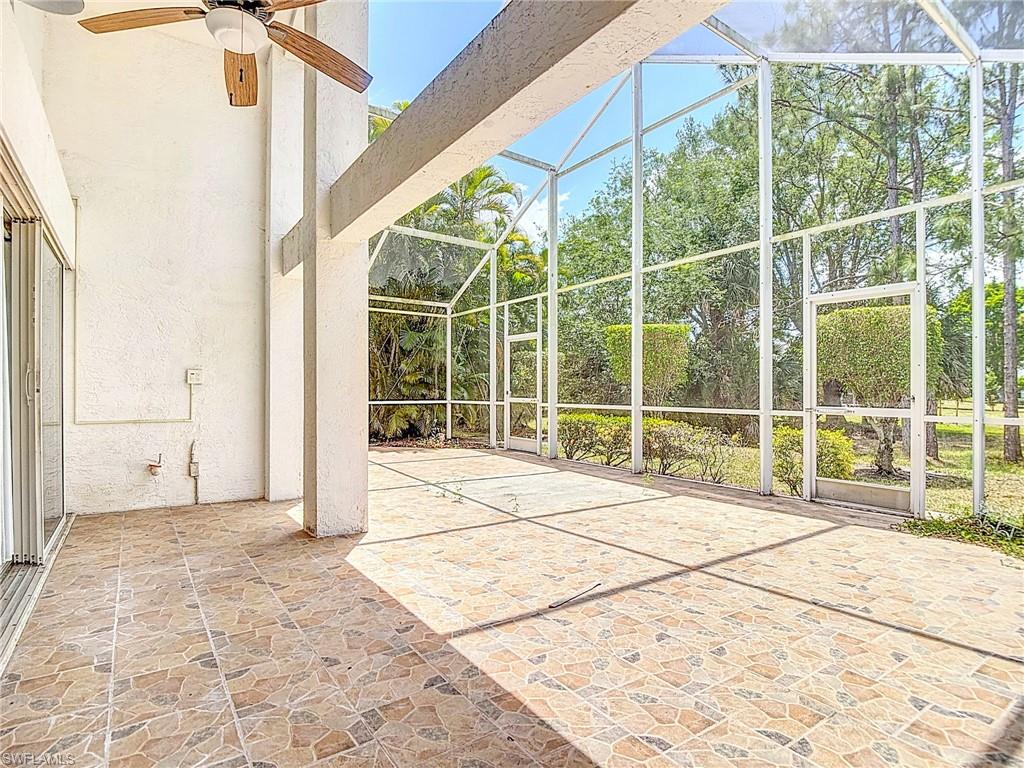 Unfurnished sunroom with a healthy amount of sunlight and ceiling fan