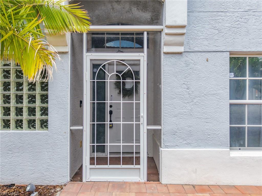 View of exterior entry with stucco siding