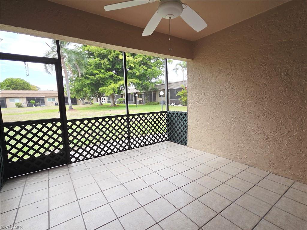 Unfurnished sunroom featuring ceiling fan