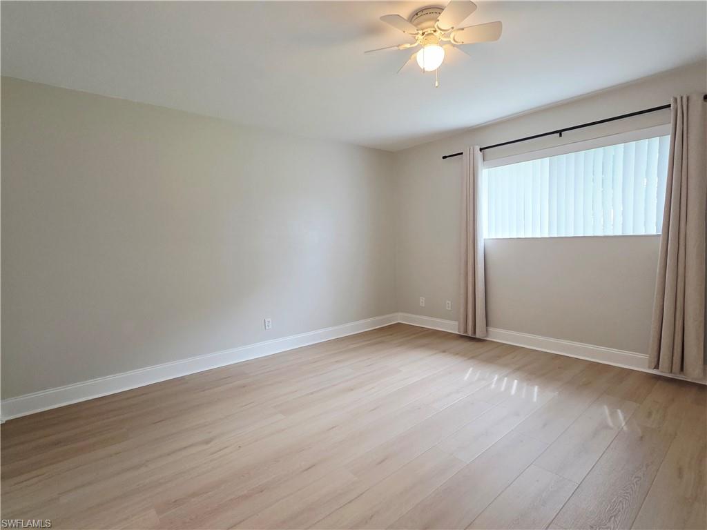 Unfurnished room featuring light wood-type flooring and ceiling fan