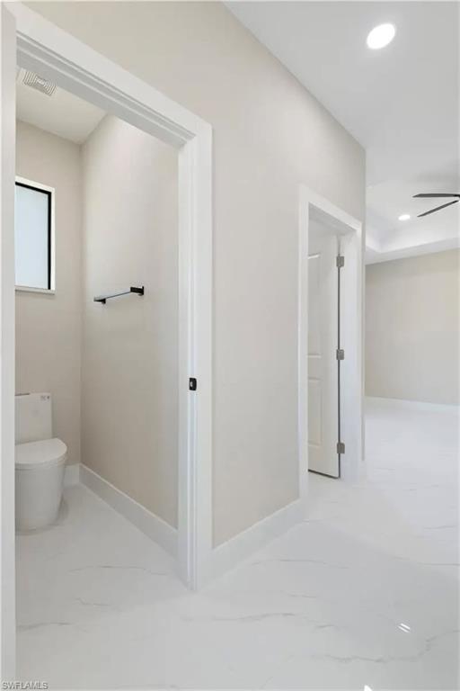 Bathroom featuring light marble finish floors, recessed lighting, and a ceiling fan
