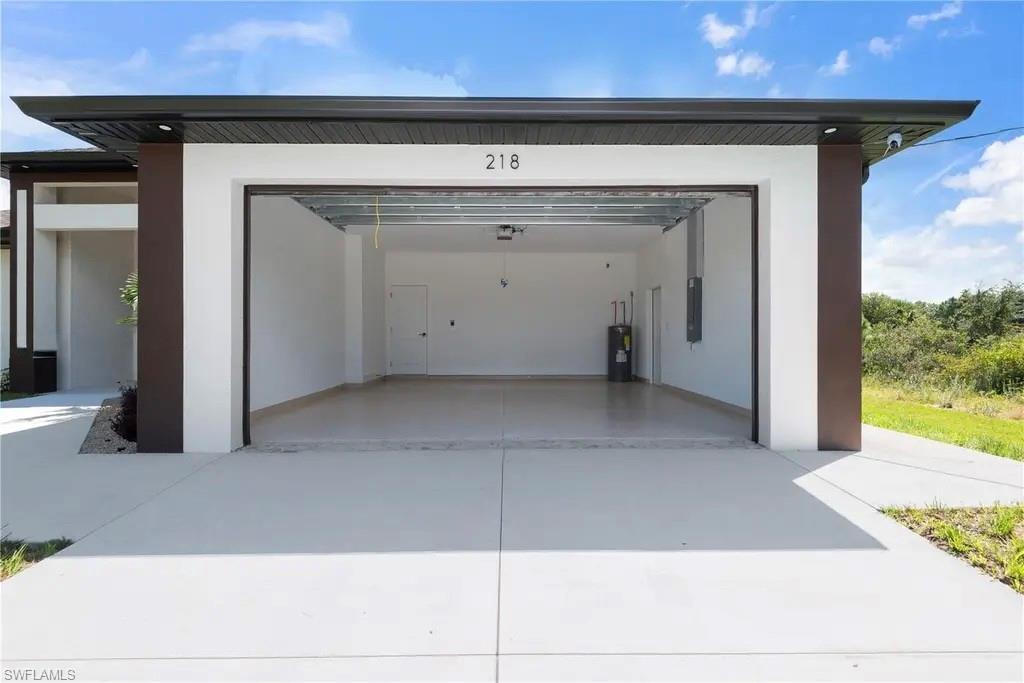 Garage with driveway and water heater
