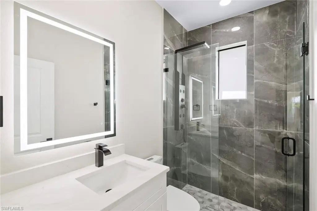 Bathroom with vanity and a stall shower
