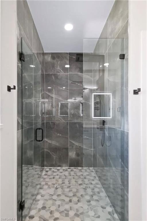 Full bathroom with a shower stall and recessed lighting