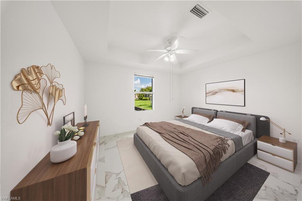 Bedroom featuring a raised ceiling, a ceiling fan, and light marble finish flooring