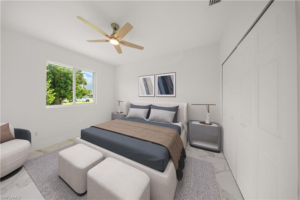 Bedroom with ceiling fan, a closet, and marble look tile flooring