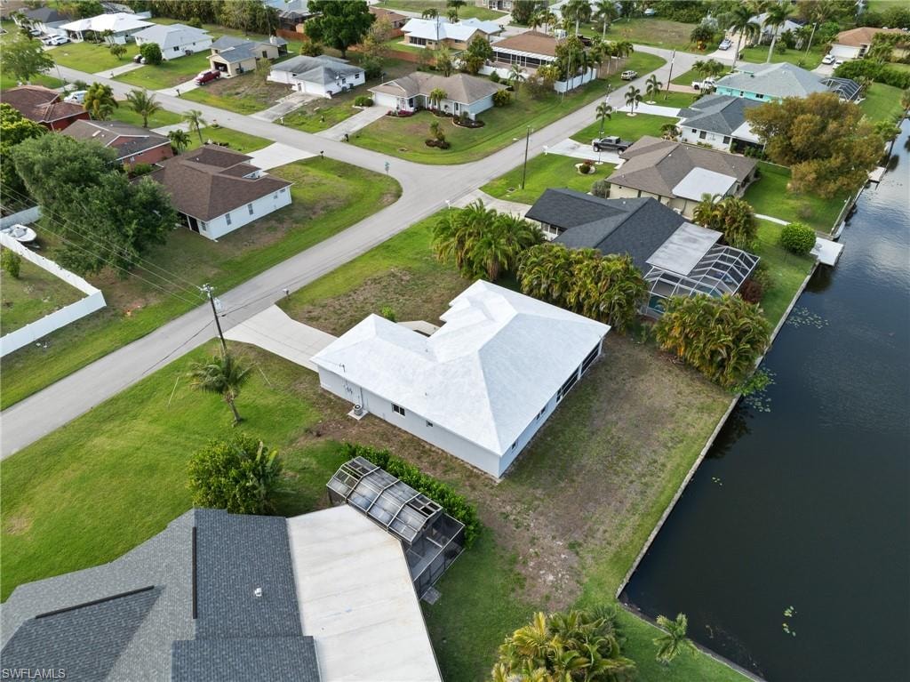 Aerial perspective of suburban area featuring a nearby body of water