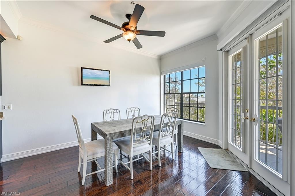 Rich wood flooring & French doors to the pool access.