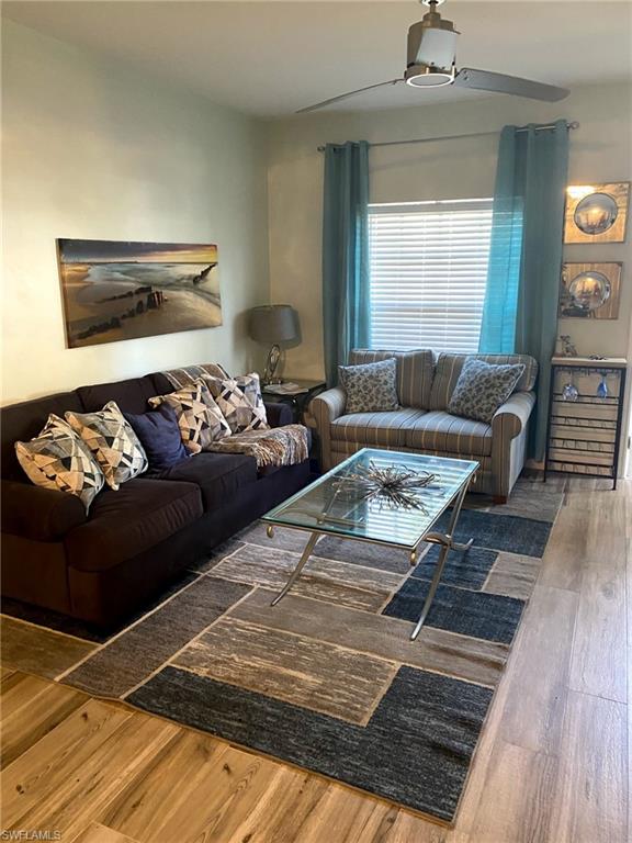 Wood-finish flooring with a modern ceiling fan and recessed lighting