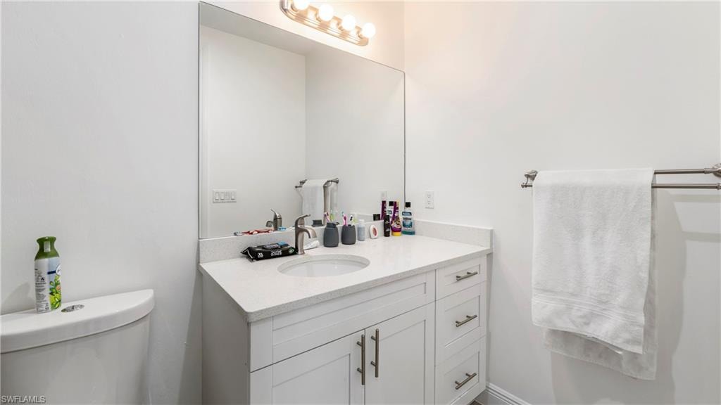 Half bath with vanity and toilet