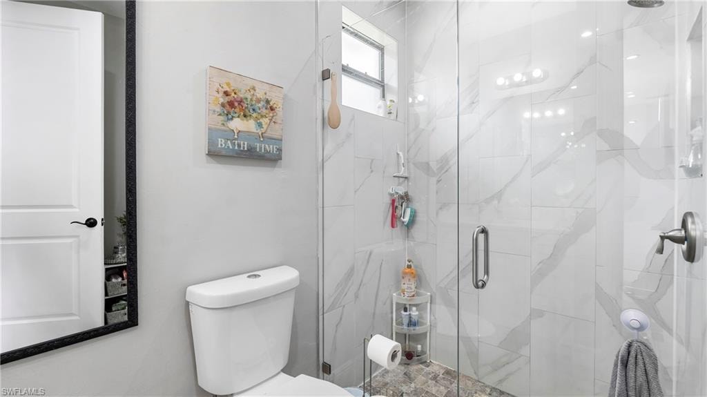 Bathroom with toilet and a stall shower