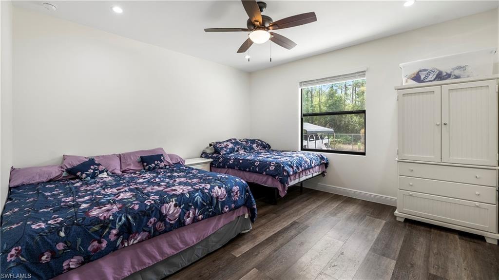 Bedroom featuring dark wood finished floors, ceiling fan, and recessed lighting
