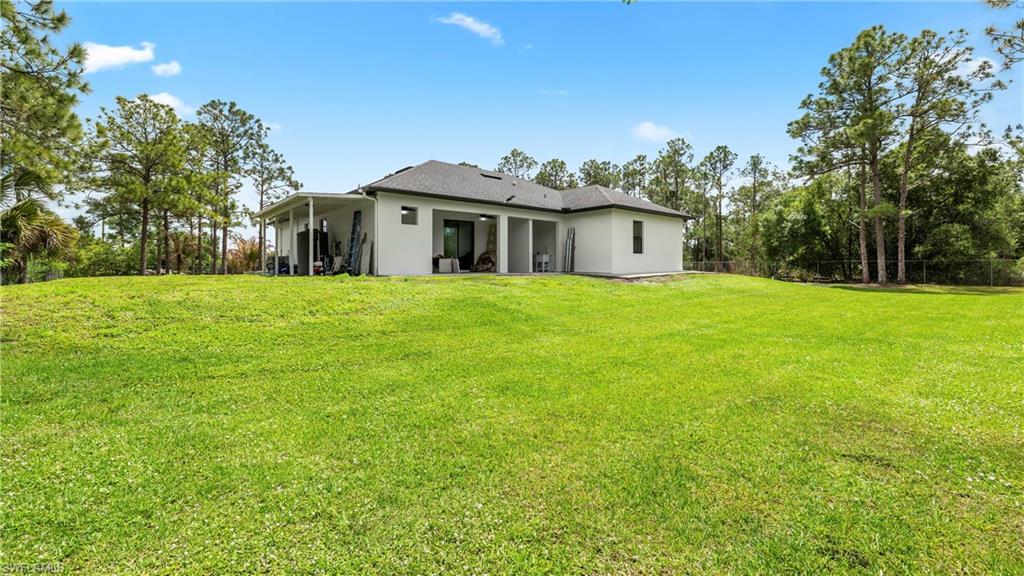Rear view of property featuring stucco siding and a patio