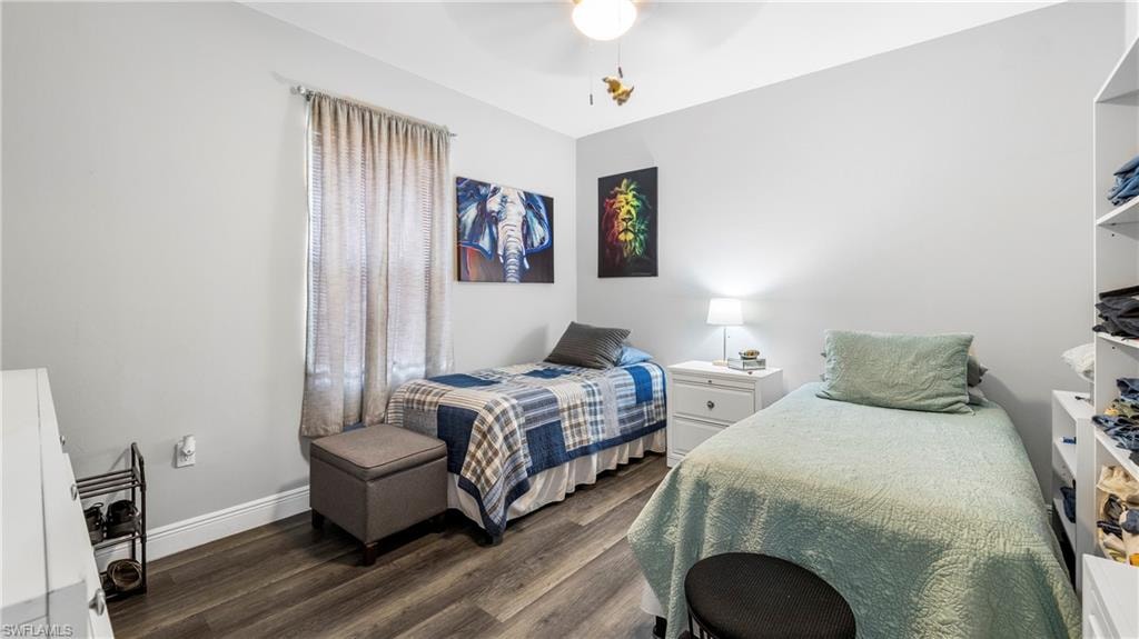 Bedroom with dark wood finished floors and ceiling fan