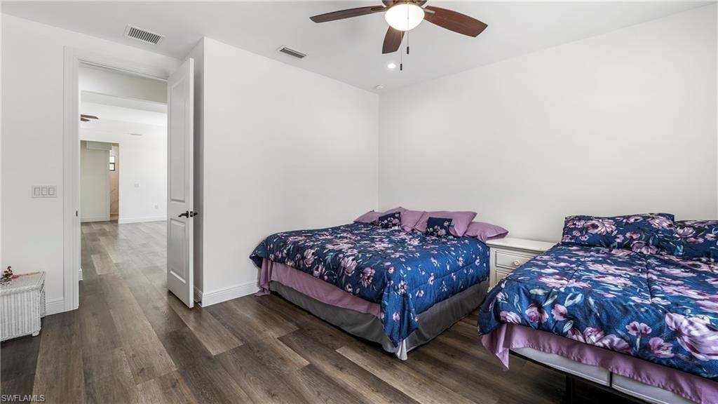 Bedroom with dark wood-style floors and ceiling fan