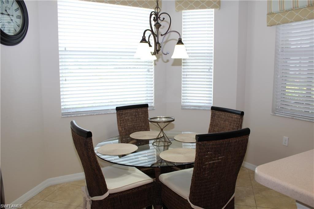 Dining room featuring an inviting chandelier, light tile patterned floors, and baseboards