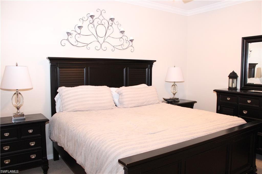 Bedroom with carpet flooring and ornamental molding