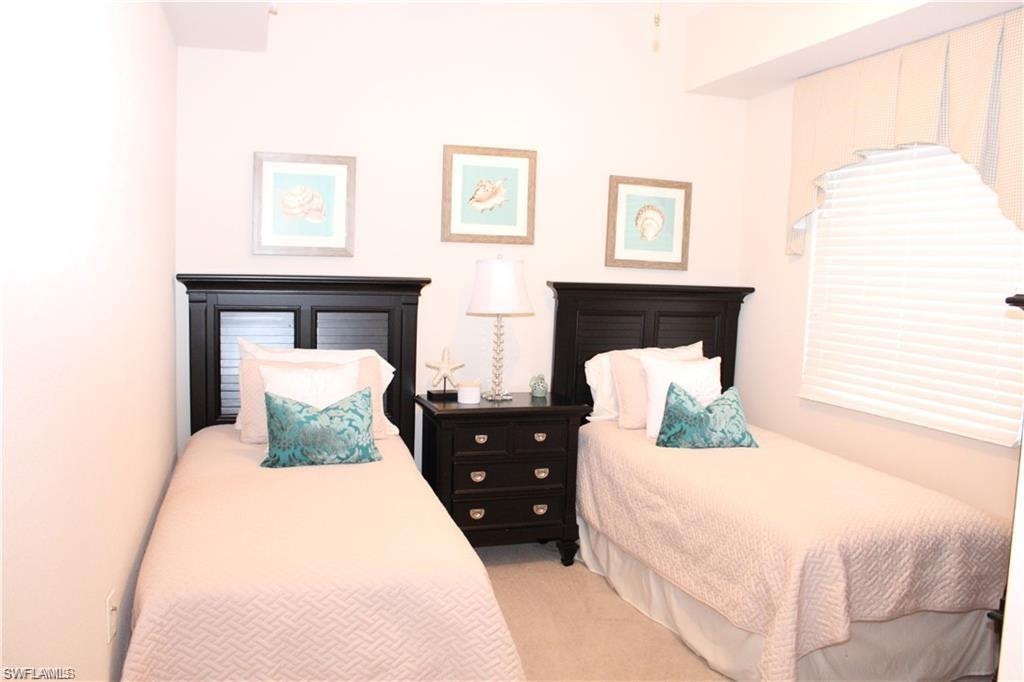 Bedroom featuring light carpet