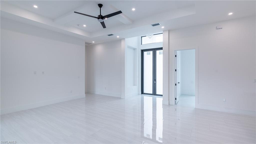 Spacious interior featuring sleek tile flooring and a contemporary ceiling fan