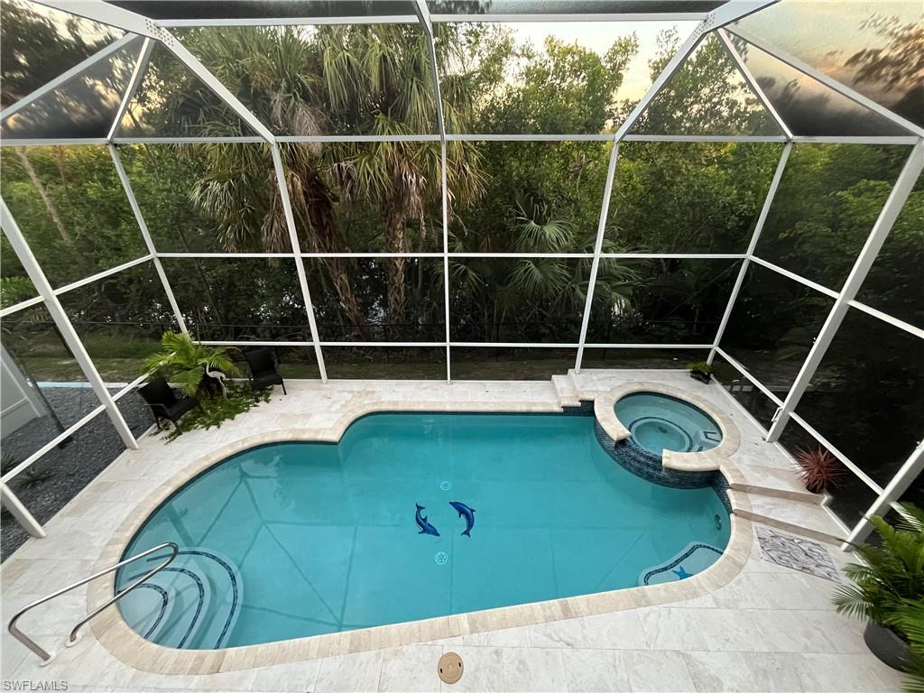Large 2 story screen enclosure with a heated pool and spa.