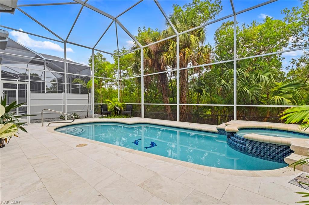 Large screened pool deck (with both a heated pool & spa) with mangroves behind you.