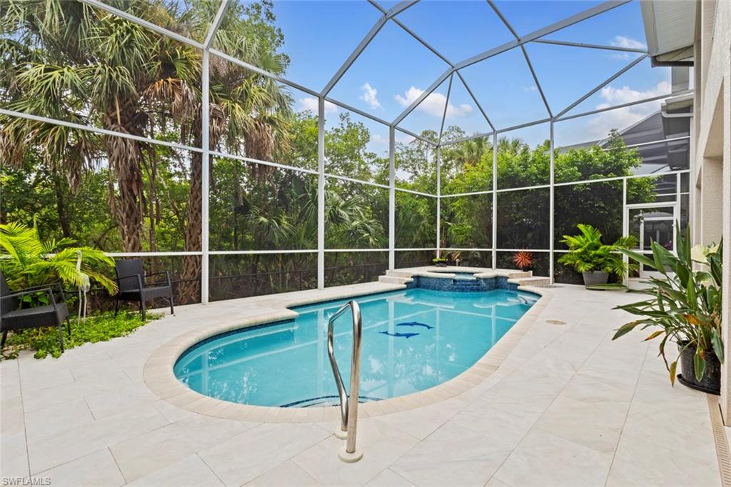 Large screened pool deck (with both a heated pool & spa) with mangroves behind you.