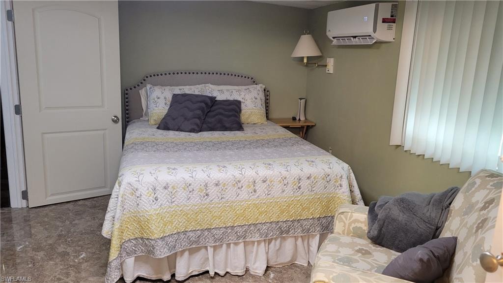 Master bedroom with queen bed, side chair and ensuite.