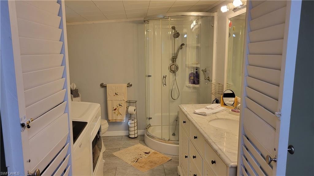 Ensuite equipped with washer, dryer, vanity and corner shower.