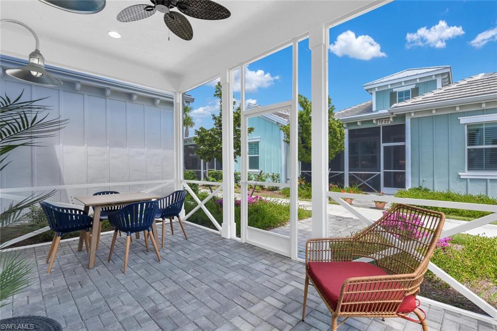 Sunroom featuring outdoor dining area and a ceiling fan