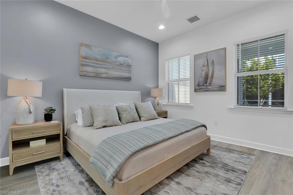 Bedroom with visible vents, baseboards, recessed lighting, and wood finished floors