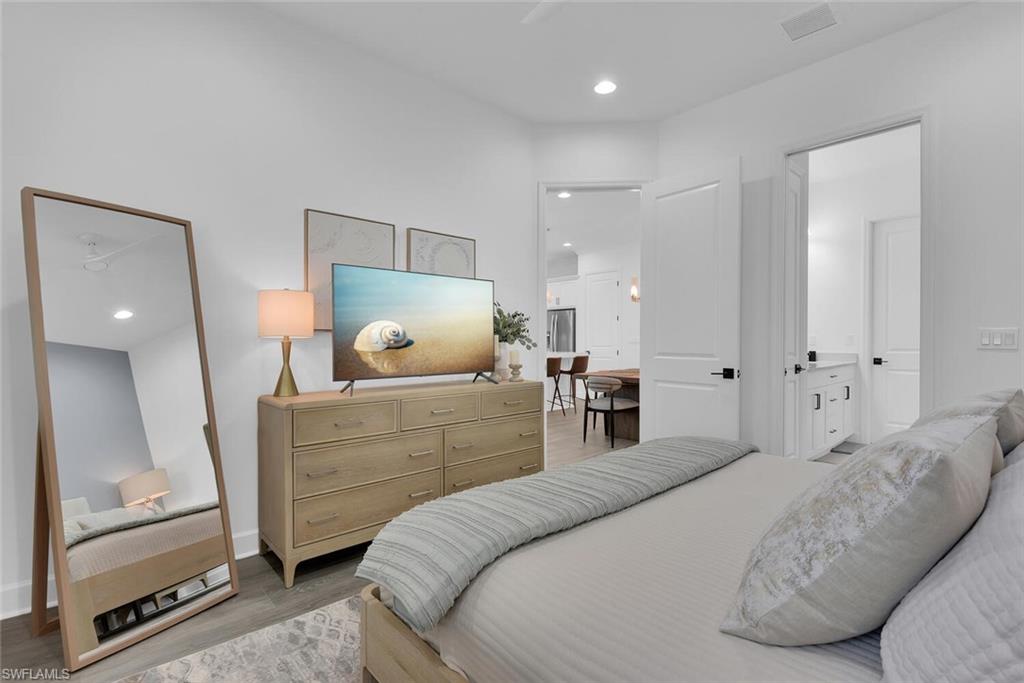 Bedroom featuring visible vents, baseboards, light wood finished floors, and recessed lighting