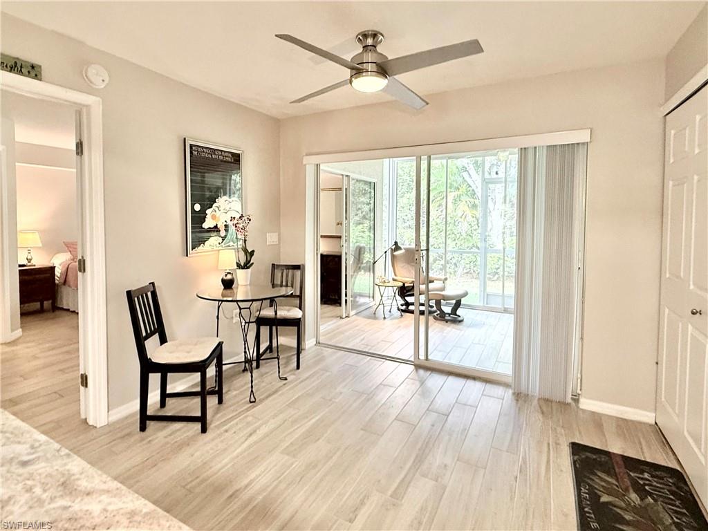 Living area with light wood finished floors and ceiling fan