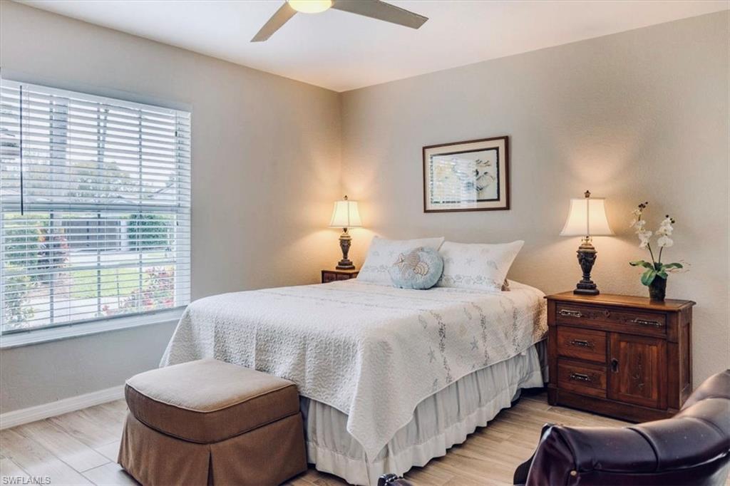 Bedroom with light wood-style floors and a ceiling fan