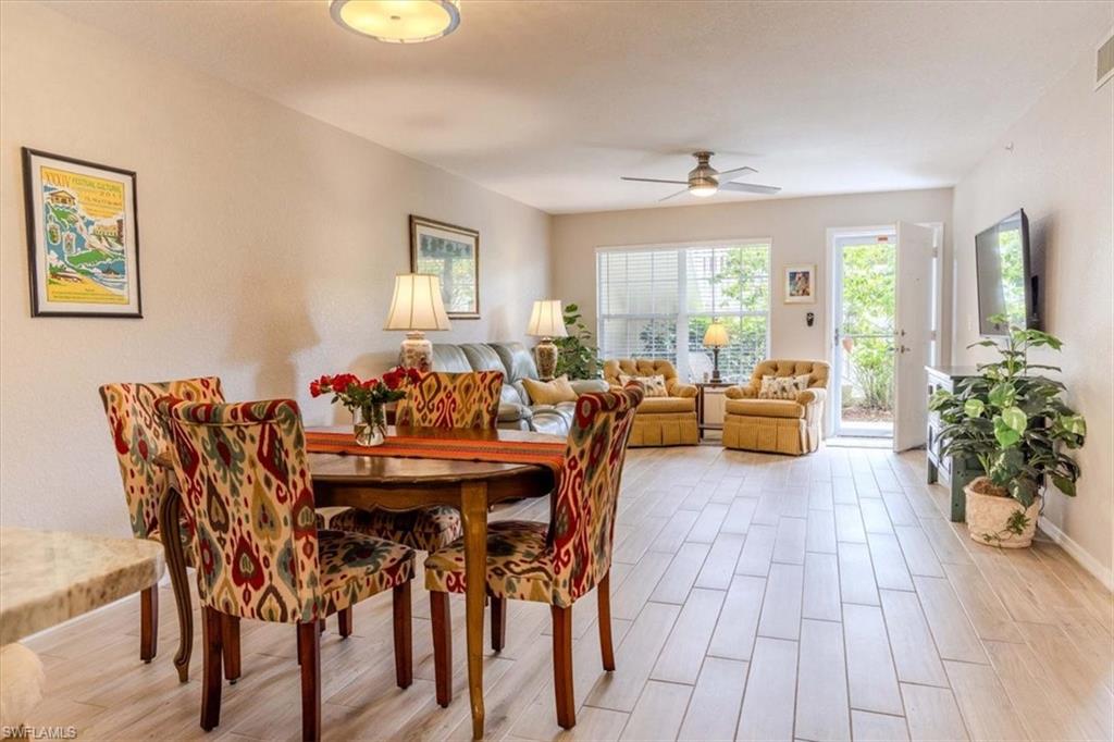 Dining room with wood tiled floors and a ceiling fan