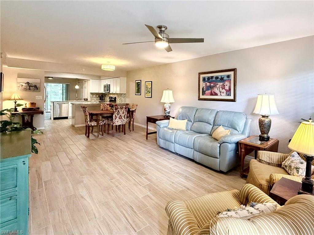 Living area with light wood-type flooring and ceiling fan