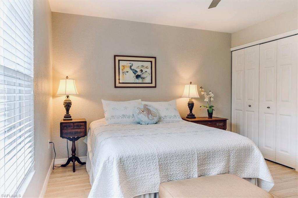 Bedroom with a closet, ceiling fan, and light wood-type flooring