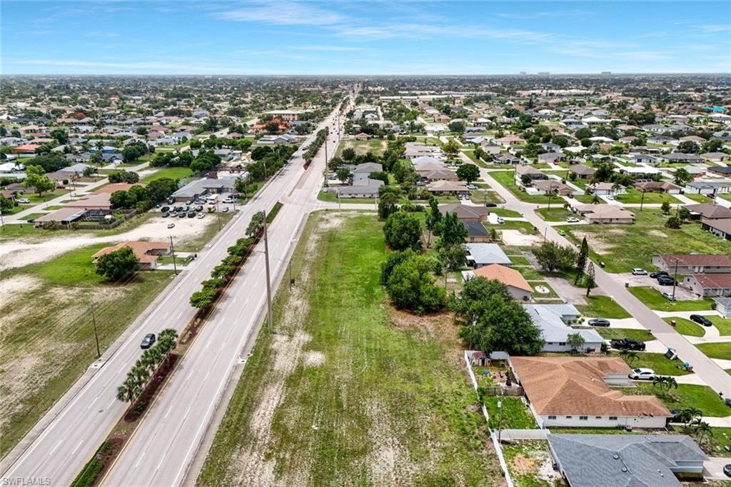 Expansive undeveloped lot featuring a grassed surface with established perimeter trees
