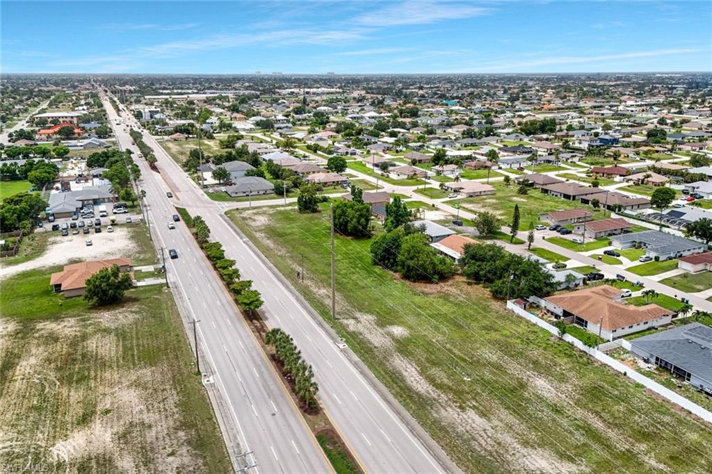 Expansive aerial perspective showcasing a residential neighborhood with numerous single-story homes